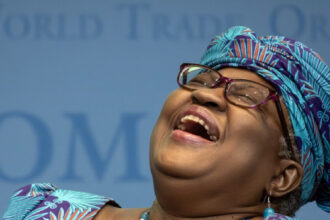 World Trade Organization (WTO) Director-General Ngozi Okonjo-Iweala reacts during a “Making trade score for women!” discussion on football as a tool for trade and development at the WTO headquarters in Geneva, on May 1, 2023. (Photo by Fabrice COFFRINI / AFP)