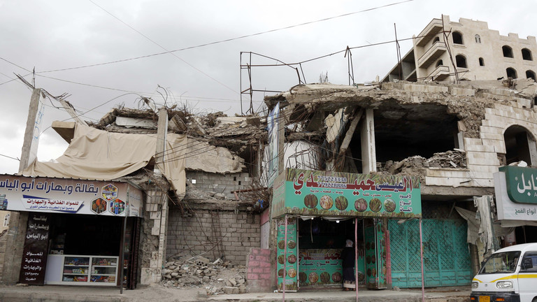 FILE PHOTO: A man buys from a shop located in a building destroyed in past aerial strikes in Sana'a, Yemen. © Mohammed Hamoud / Getty Images