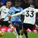 Fulham’s English-born US defender #33 Antonee Robinson (R) vies with Arsenal’s English midfielder #07 Bukayo Saka (C) during the English Premier League football match between Fulham and Arsenal at Craven Cottage in London on December 8, 2024. (Photo by JUSTIN TALLIS / AFP)