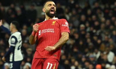 Liverpool’s Egyptian striker #11 Mohamed Salah celebrates after scoring their fourth goal during the English Premier League football match between Tottenham Hotspur and Liverpool at the Tottenham Hotspur Stadium in London, on December 22, 2024. (Photo by Glyn KIRK / AFP) /