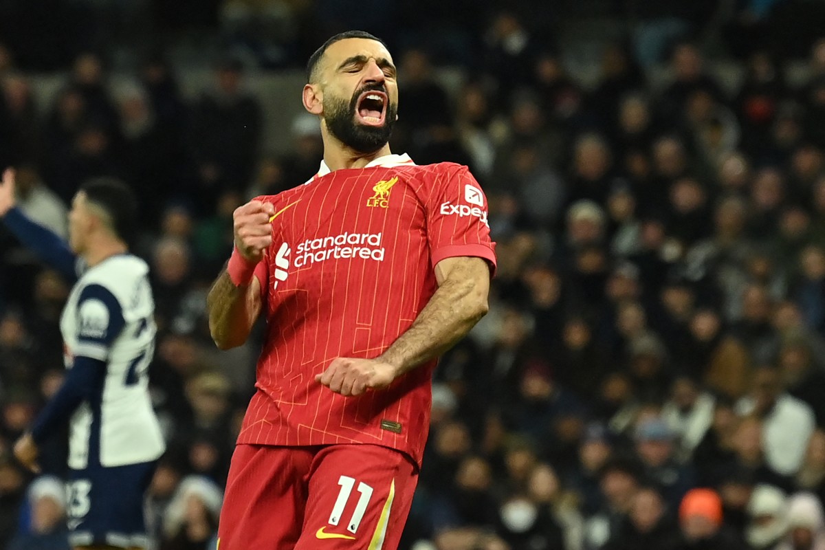 Liverpool’s Egyptian striker #11 Mohamed Salah celebrates after scoring their fourth goal during the English Premier League football match between Tottenham Hotspur and Liverpool at the Tottenham Hotspur Stadium in London, on December 22, 2024. (Photo by Glyn KIRK / AFP) /