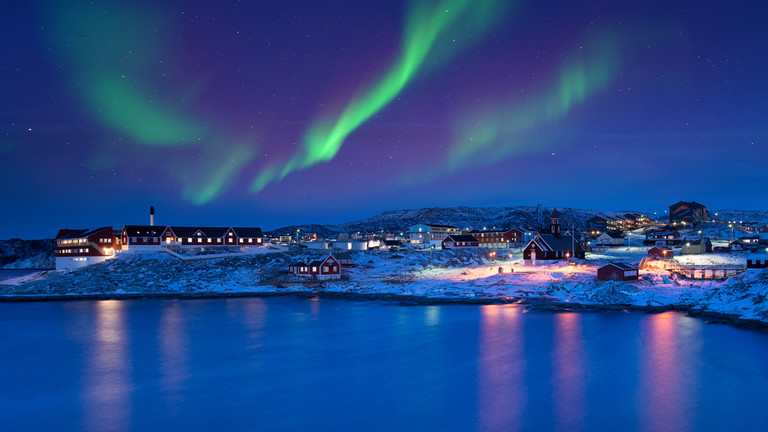 FILE PHOTO: Polar lights over Ilulissat, Greenland © Getty Images / nevereverro