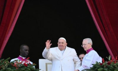 Pope Francis waves from the main balcony of St. Peter’s basilica after the Urbi et Orbi message and blessing to the city and the world as part of Christmas celebrations, at St Peter’s square in the Vatican on December 25, 2024. (Photo by Alberto PIZZOLI / AFP)