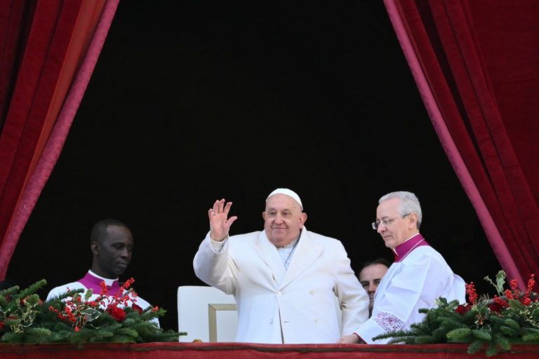 Pope Francis waves from the main balcony of St. Peter’s basilica after the Urbi et Orbi message and blessing to the city and the world as part of Christmas celebrations, at St Peter’s square in the Vatican on December 25, 2024. (Photo by Alberto PIZZOLI / AFP)