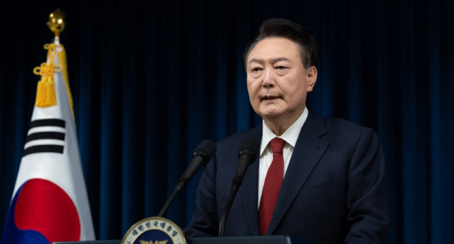 This handout photo taken and released on December 7, 2024 by the South Korean Presidential Office shows South Korea’s President Yoon Suk Yeol delivering an address at the Presidential Office in Seoul. (Photo by Handout / South Korean Presidential Office / AFP)