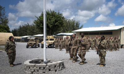 FILEPHOTO. In this Aug. 26, 2019 file photo released by the U.S. Air Force, airmen from the 475th Expeditionary Air Base Squadron conduct a flag-raising ceremony, signifying the change from tactical to enduring operations, at Camp Simba, Manda Bay, Kenya. © Staff Sgt. Lexie West/U.S. Air Force via AP