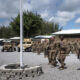 FILEPHOTO. In this Aug. 26, 2019 file photo released by the U.S. Air Force, airmen from the 475th Expeditionary Air Base Squadron conduct a flag-raising ceremony, signifying the change from tactical to enduring operations, at Camp Simba, Manda Bay, Kenya. © Staff Sgt. Lexie West/U.S. Air Force via AP