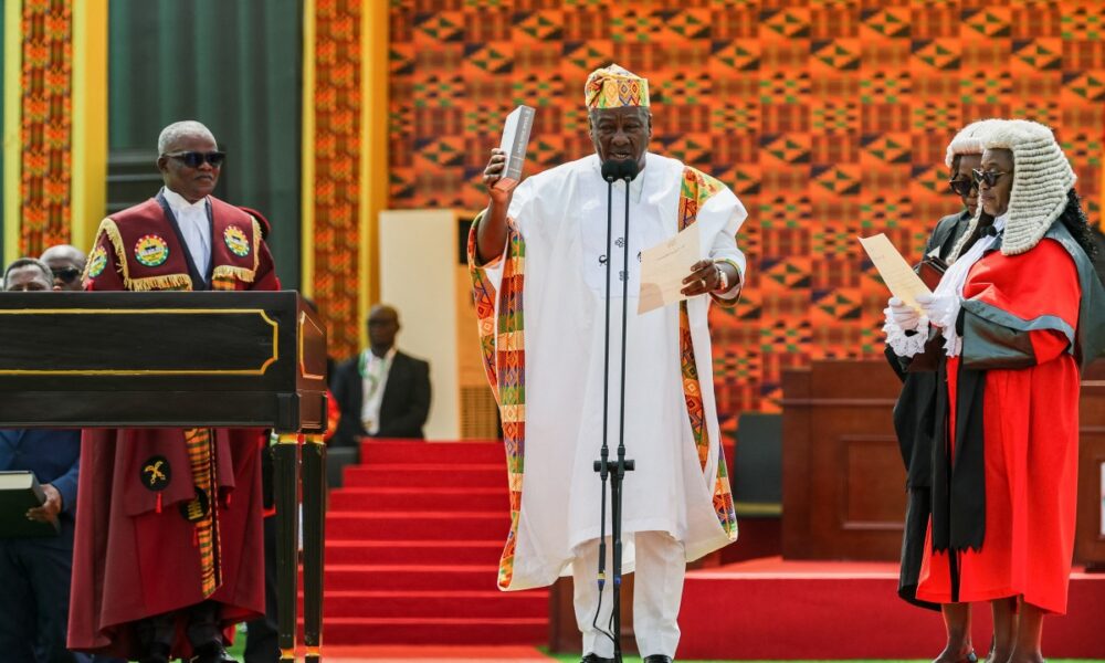 Ghana’s new President John Mahama (C) holds a Bible as he takes oath of office at his inauguration at the Independence Square in Accra on January 7, 2025.(Photo by Nipah Dennis / AFP)