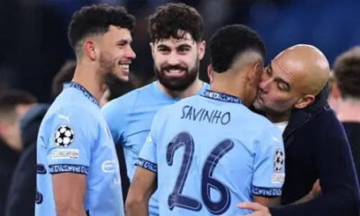 Manchester City manager Pep Guardiola plants a kiss on Savinho after his goal helped them into the Champions League play-offs with victory over Club Brugge