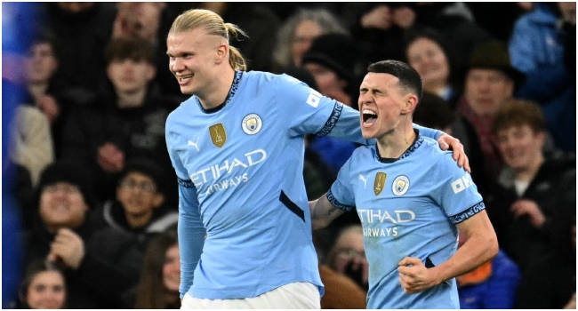 Manchester City’s English midfielder #47 Phil Foden (R) celebrates scoring the team’s third goal with Manchester City’s Norwegian striker #09 Erling Haaland during the English Premier League football match between Manchester City and Chelsea at the Etihad Stadium in Manchester, north west England, on January 25, 2025. Manchester City won the match 3-1. (Photo by Oli SCARFF / AFP)