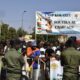 People carry a sign in support of the Alliance of Sahel States (AES) during a gathering to celebrate the withdrawal of Mali, Niger and Burkina Faso from the Economic Community of West African States (ECOWAS) in Niamey on January 28, 2025. Photo by Boureima Hama / AFP)