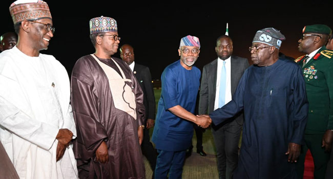 President Bola Tinubu shakes his Chief of Staff, Femi Gbajabiamila, and other top government officials upon his arrival to Abuja from Tanzania on January 28, 2025.