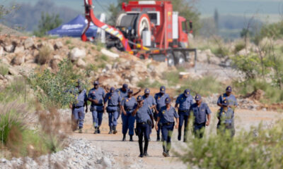 South African Police Service (SAPS) officers walk near a Metalliferous Mobile Rescue Winder during a rescue operation to retrieve illegal miners from an abandoned gold shaft in Stilfontein on January 13, 2025. (Photo by Christian Velcich / AFP)