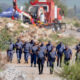 South African Police Service (SAPS) officers walk near a Metalliferous Mobile Rescue Winder during a rescue operation to retrieve illegal miners from an abandoned gold shaft in Stilfontein on January 13, 2025. (Photo by Christian Velcich / AFP)