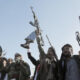 Yemen’s Houthis brandish weapons during a rally in Sanaa, Yemen on January 17, 2025. © Mohammed Hamoud / Getty Images