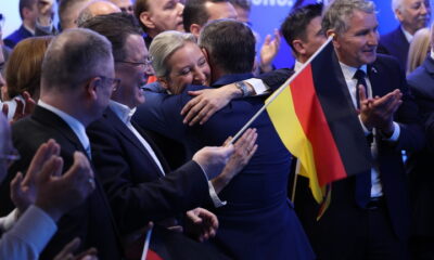 Alice Weidel (R), co-leader and chancellor candidate of the far-right Alternative for Germany (AfD), hugs AfD co-leader Tino Chrupalla at AfD headquarters after initial results in snap federal parliamentary elections on February 23, 2025 in Berlin, Germany. © Sean Gallup/Getty Images