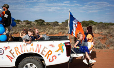 An Afrikaner cheerleading group looks at onlookers during a parade @ Per-Anders Pettersson/Getty Images