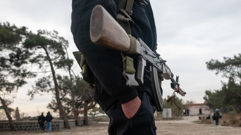 FILE PHOTO: Hayat Tahrir al-Sham (HTS) fighters patrol in the city of Homs, Syria, January 22, 2025. © Getty Images / Spencer Platt