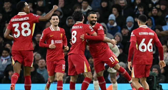 Liverpool’s Hungarian midfielder #08 Dominik Szoboszlai celebrates scoring the team’s second goal with Liverpool’s Egyptian striker #11 Mohamed Salah during the English Premier League football match between Manchester City and Liverpool at the Etihad Stadium in Manchester, north west England, on February 23, 2025. (Photo by Paul ELLIS / AFP)