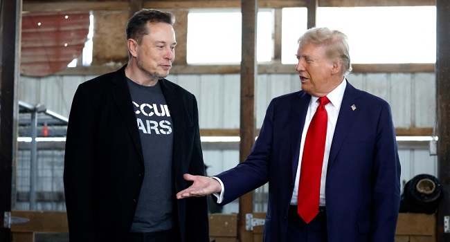 (FILES) Donald Trump offers his hand to Tesla and SpaceX CEO Elon Musk back stage during a campaign rally at the Butler Farm Show grounds on October 05, 2024 in Butler, Pennsylvania. (Photo by Anna Moneymaker / GETTY IMAGES NORTH AMERICA / AFP)