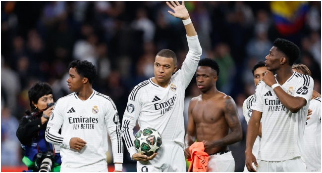 Real Madrid’s French forward #09 Kylian Mbappe (C) reacts at the end of the UEFA Champions League knockout phase play-off football match between Real Madrid CF and Manchester City at the Santiago Bernabeu stadium in Madrid on February 19, 2025. (Photo by OSCAR DEL POZO / AFP)