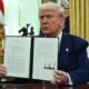 US President Donald Trump displays his signature on an Executive Order on reciprocal tariffs in the Oval Office of the White House in Washington, DC, on February 13, 2025. (Photo by ANDREW CABALLERO-REYNOLDS / AFP)